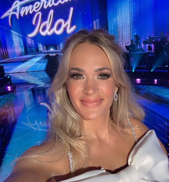 Carrie Underwood, American Idol, Fashion Icon, Giant Bow, Fashion Buzz, Red Carpet Style, Celebrity Fashion, Style Inspiration, Fashion Trends, Women Empowerment, Fashion Statement, Bold Fashion, Music and Fashion, Pop Culture, Stylish Looks,